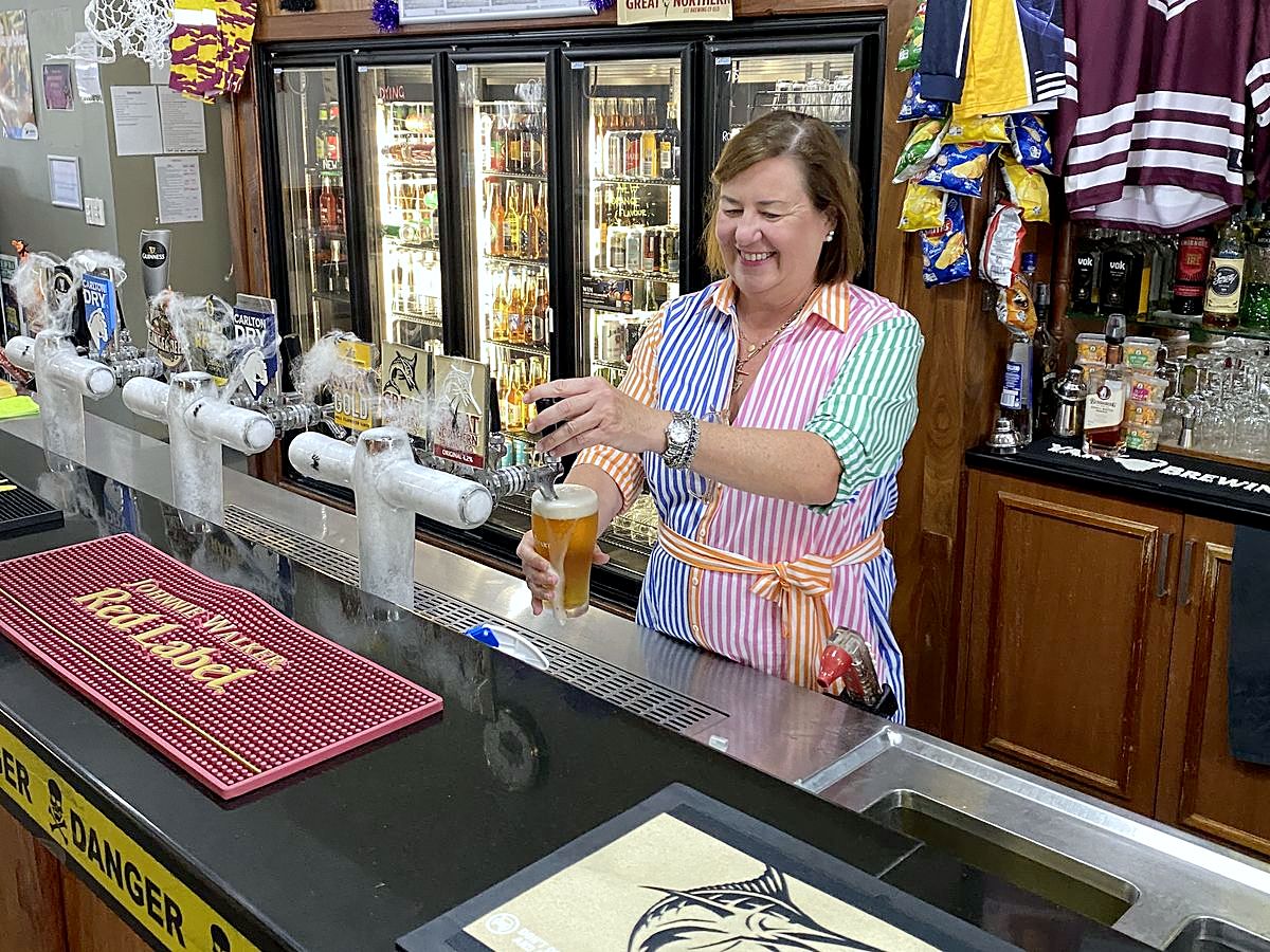 Pouring a cold beer behind the bar at Dooleys Tavern